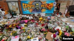 Items left by protesters to memorialize George Floyd, who died in Minneapolis police custody, are seen at the scene of his arrest in Minneapolis, Minnesota, June 4, 2020. 
