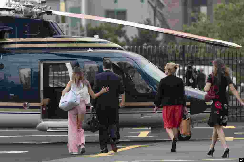 New York Gov. Andrew Cuomo and others walk towards a helicopter at a Manhattan heliport. Cuomo announced his resignation over a barrage of sexual harassment as momentum built in the Legislature to remove him by impeachment.