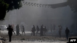 პალესტინელები ღაზის სექტორის ერთ-ერთ უბანში მოქალაქეების ევაკუაციას ცდილობენ, 11 ოქტომბერი, 2023 წ. 