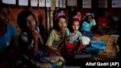 FILE - In this Aug. 27, 2018, photo, Rohingya refugee children attend a UNICEF run school in Balukhali refugee camp, Bangladesh. (AP Photo/Altaf Qadri)