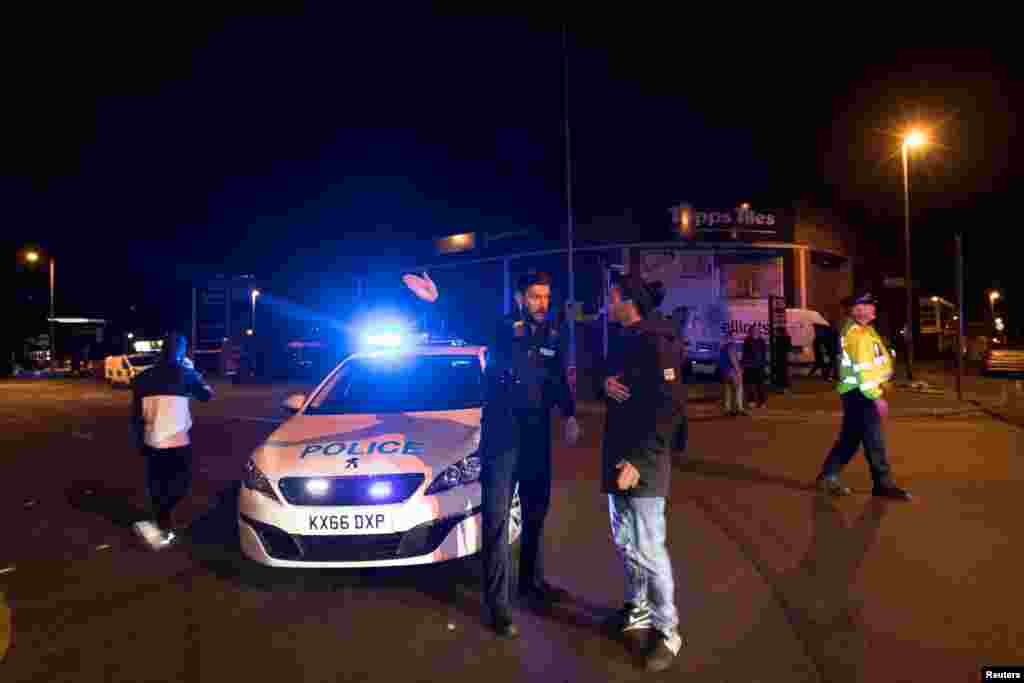 Police set up a cordon outside the Manchester Arena in northern England where U.S. singer Ariana Grande had been performing in Manchester, Britain, May 22, 2017.