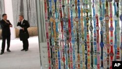 FILE - Swatch watches are displayed on the wall of an elevator at a Swatch Group's store in Japan, in Tokyo, on May 24, 2007. Swiss watchmaker Swatch said Tuesday, May 23, 2023, that Malaysian authorities raided its stores and confiscated 164 watches from its Pride Collection.