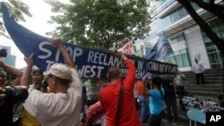 Demonstrators rally at the Chinese Consulate at the financial district of Makati city, The Philippines, to protest China's reclamations of disputed islands off South China Sea, July 3, 2015. The reclamations have strained U.S.-China relations.