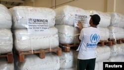 FILE - A UNHCR employee arranges aid at the Dubai International Humanitarian city in Dubai, United Arab Emirates, before shipping it to Yemen, May 14, 2015. 
