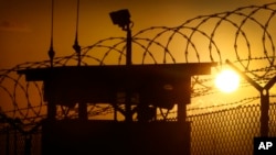 FILE - The sun rises above Camp Delta at Guantanamo Bay Naval Base, Cuba, May 31, 2014.