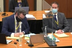 Former Minneapolis police officer Derek Chauvin attends the eleventh day of his trial, with his defense attorney Eric Nelson, in Minneapolis, Minnesota, April 12, 2021, in a still image from video.